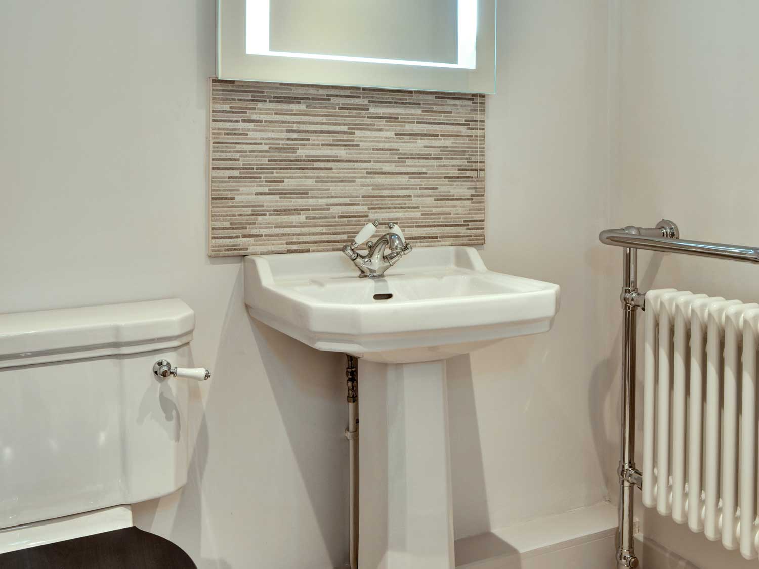 A clean and well lit bathroom with white porcelain